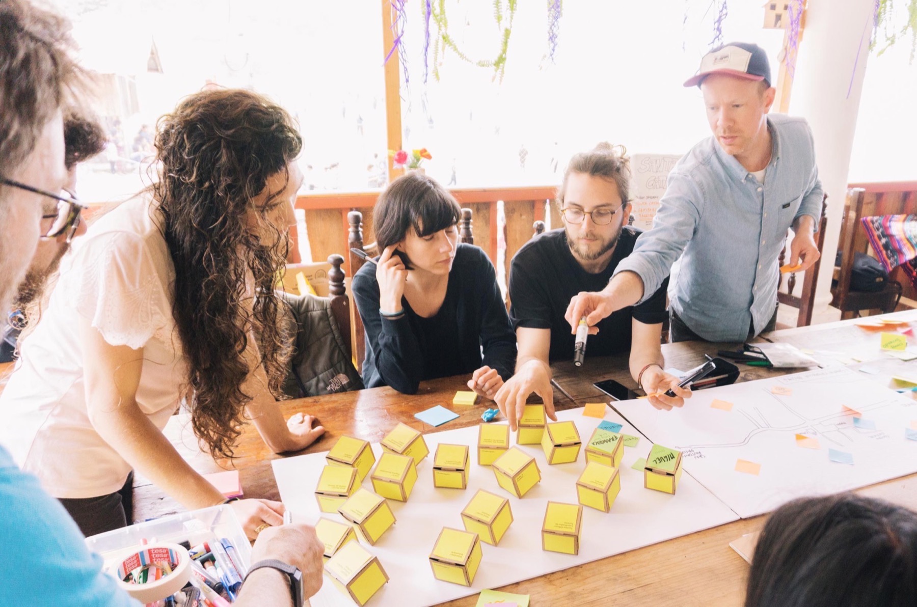 A group building with paper cubes in a workshop
